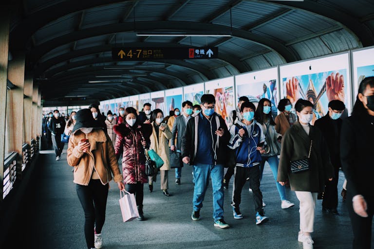 Commuters wearing masks at a busy Shanghai train station during the pandemic.