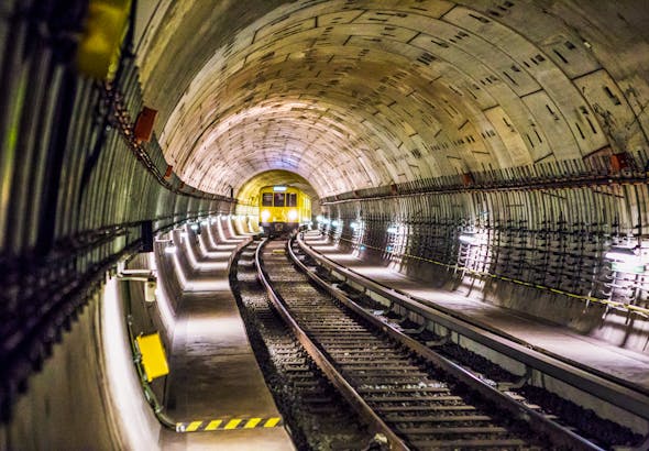Dramatic view of a Berlin subway tunnel with train approaching, showcasing modern infrastructure.